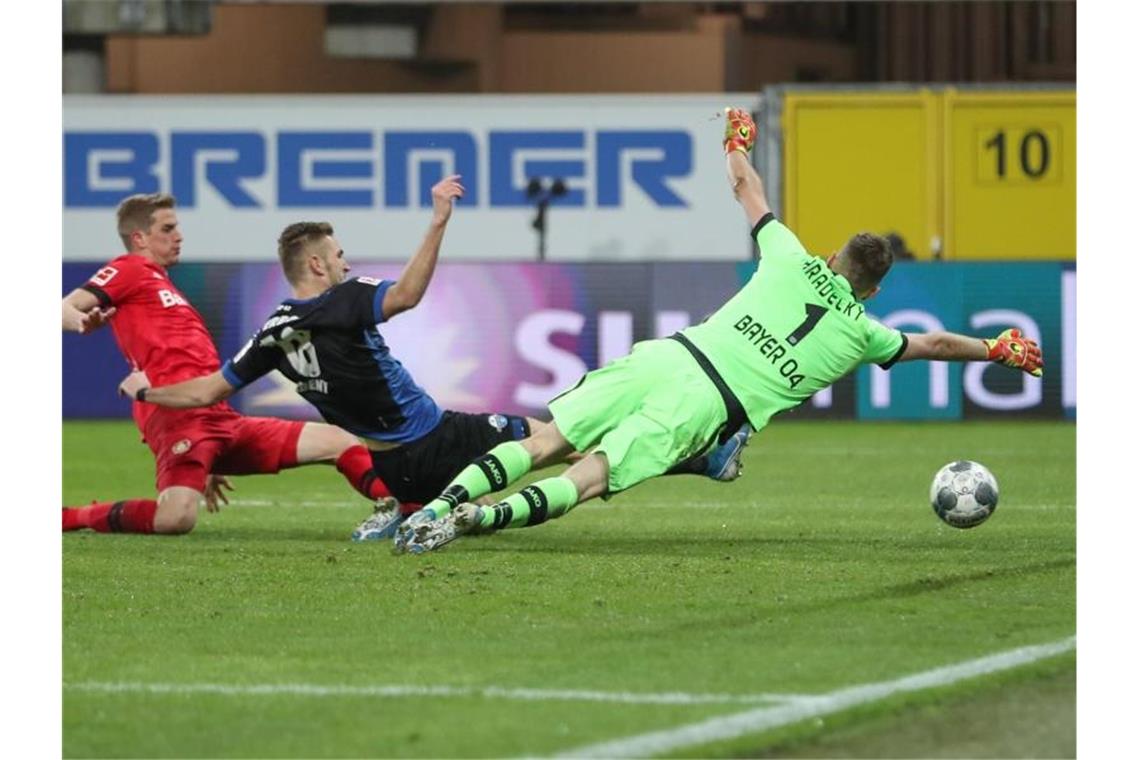 Gute erste Hälfte und Volland: Leverkusen siegt in Paderborn Paderborns Srbeny (M) erzielt den Treffer zum zwischenzeitlichen 1:3 - Bayers Schlussmann Hradecky streckt sich vergebens. Foto: Friso Gentsch/dpa