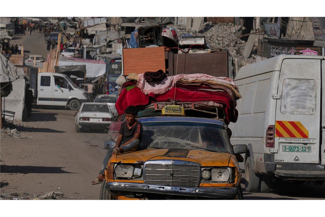 Palästinenser fliehen aus dem nördlichen Gazastreifen mit einem uralten Mercedes, auf den sie ihre Habseligkeiten geladen haben.