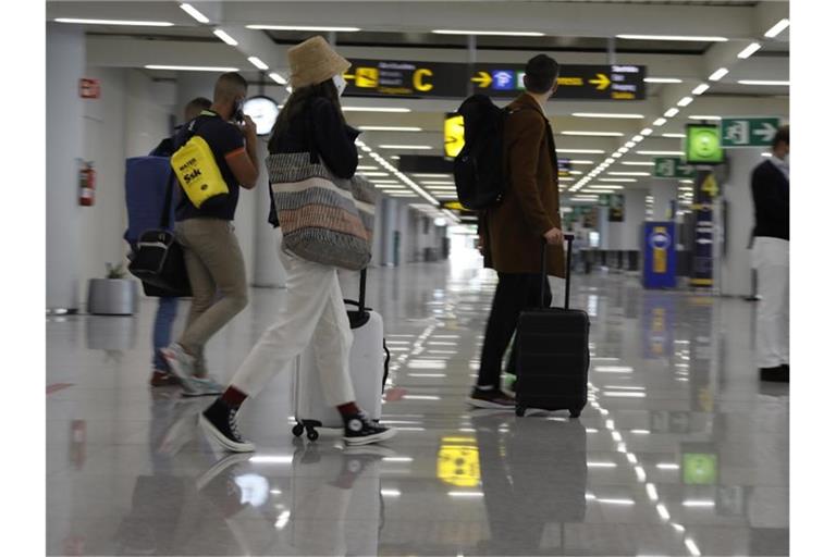Passagiere kommen am Flughafen von Mallorca an. Foto: Clara Margais/dpa