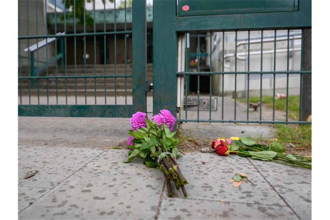 Passanten haben Blumen vor dem Eingangsbereich der Hamburger Synagoge abgelegt. Foto: Jonas Walzberg/dpa