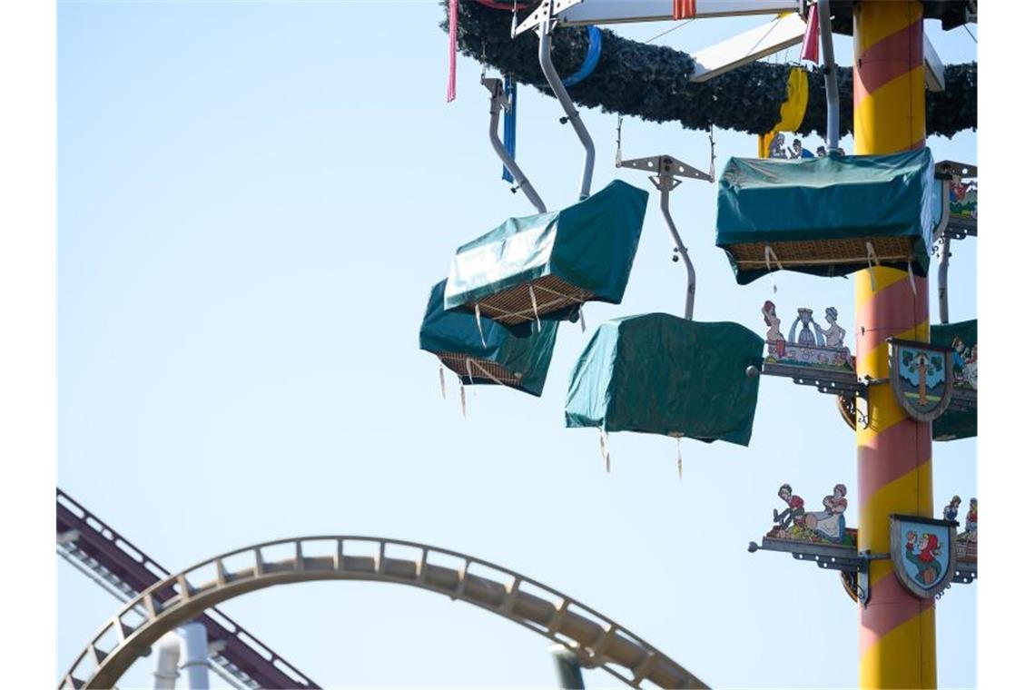 Planen decken im Freizeitpark Tripsdrill die Gondeln der Attraktion „Maibaum“ ab. Foto: Sebastian Gollnow/dpa/Archivbild