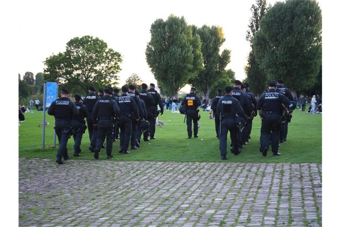 Längeres Aufenthaltsverbot für Neckarwiese in Heidelberg Polizeibeamte gehen über die Neckarwiese. Foto: Rene Priebe/dpa/Archivbild