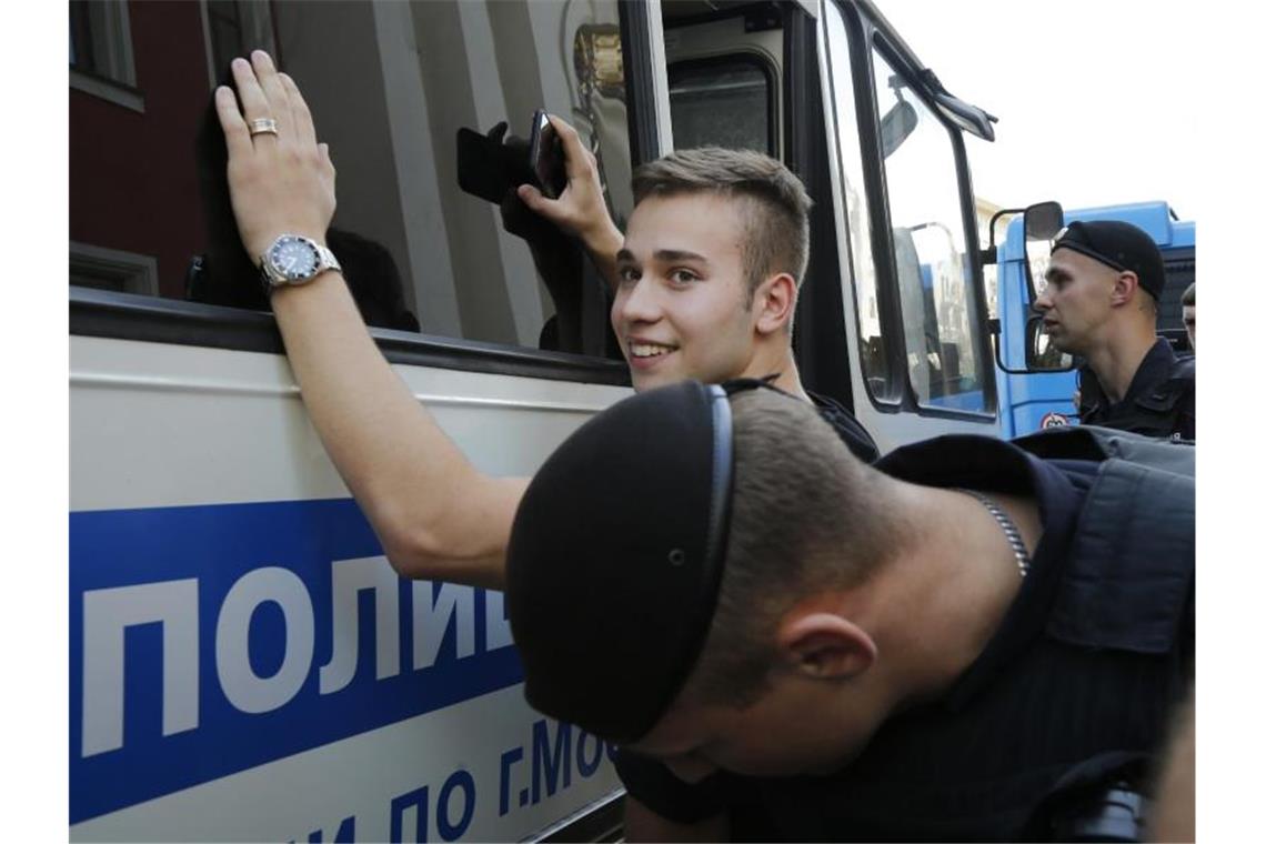 Aktivisten: 1370 Festnahmen bei Kundgebung in Moskau Polizeibeamte tasten einen festgenommenen Demonstranten ab. Foto: Alexander Zemlianichenko/AP