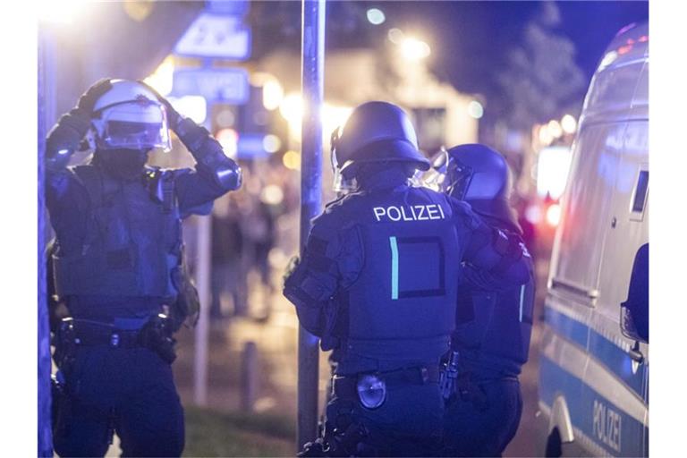 Polizeieinheiten sammeln sich, um gegen Randalierer vorzugehen. Foto: Simon Adomat/dpa/Archivbild
