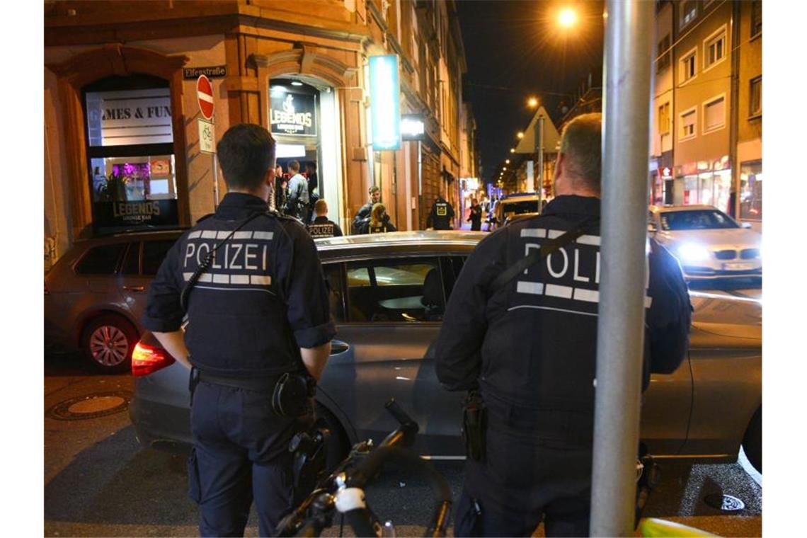 Polizisten stehen vor einem Lokal. Foto: René Priebe/PR-Video/dpa