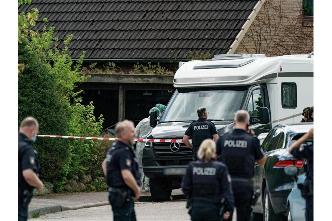 Polizisten untersuchen das Haus, in dem zwei Tote gefunden wurden. Foto: Axel Heimken/dpa