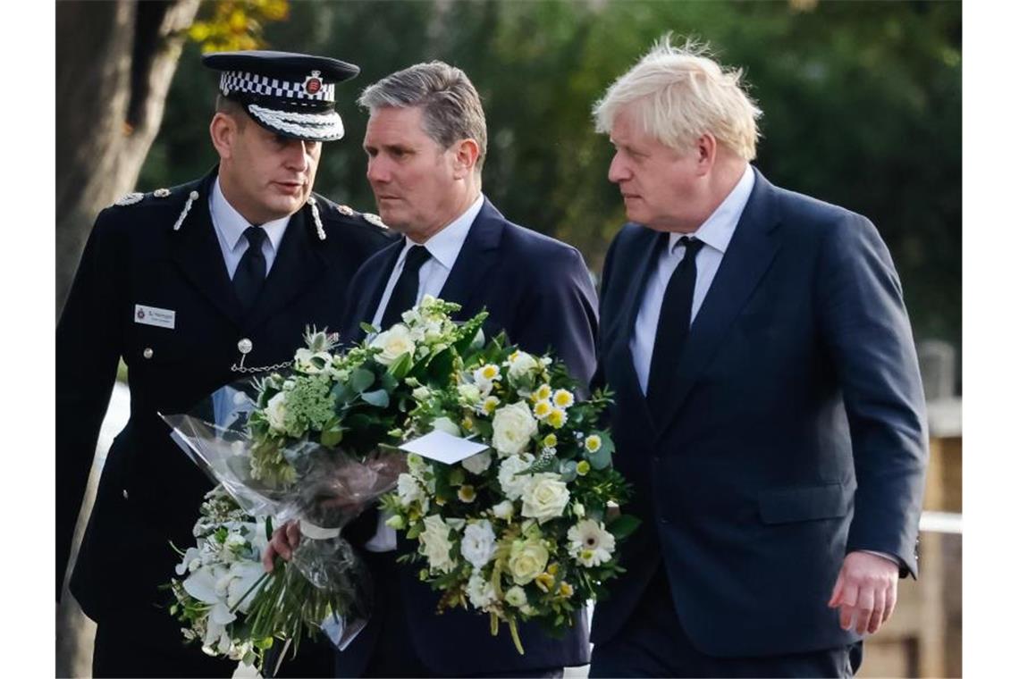 Attentat auf Abgeordneten löst Demokratiedebatte aus Premierminister Boris Johnson (r) zusammen mit Labour-Parteichef Keir Starmer (M) mit Blumen am Tatort. Foto: Dominic Lipinski/PA Wire/dpa