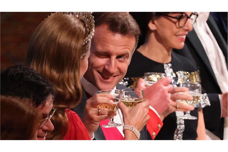 Prösterchen! Frankreichs Staatspräsident zwinkert beim Anstoßen seiner Nebensitzerin Prinzessin Kate zu.