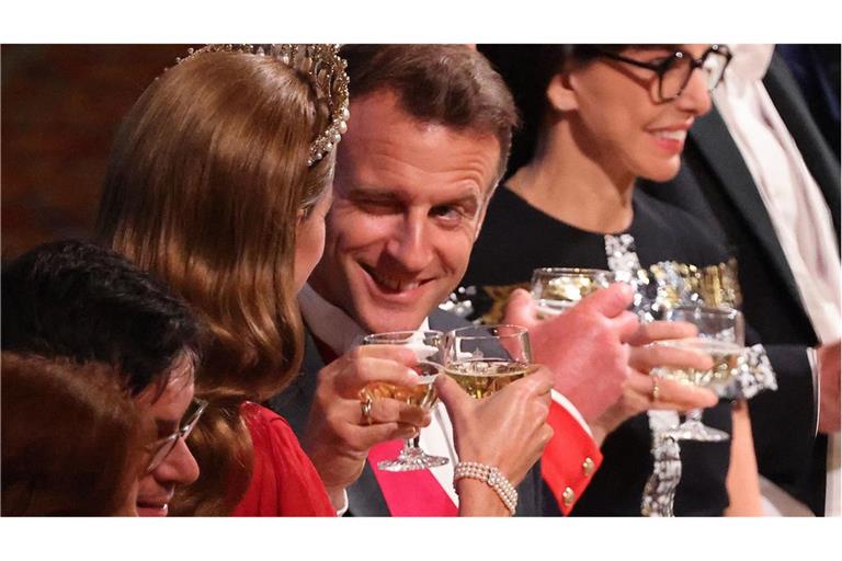 Prösterchen! Frankreichs Staatspräsident zwinkert beim Anstoßen seiner Nebensitzerin Prinzessin Kate zu.