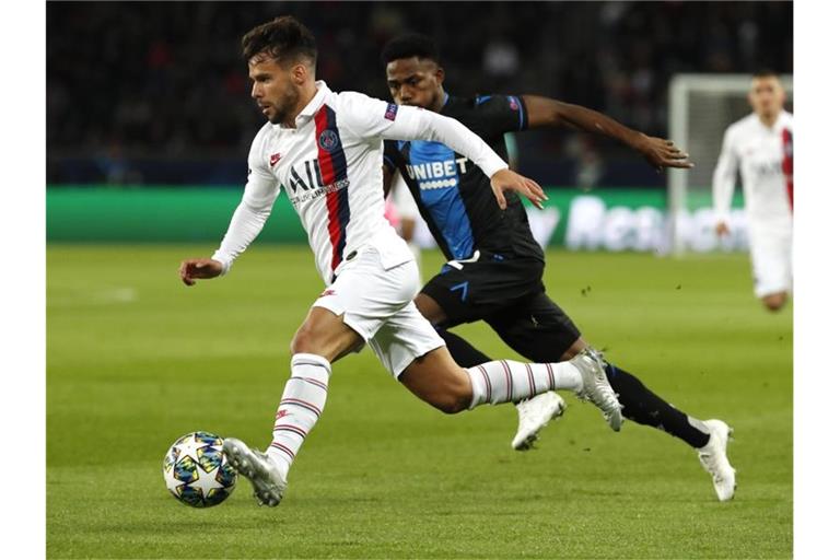 PSG-Spieler Juan Bernat (l) behauptet sich gegen Emmanuel Dennis vom FC Brügge. Foto: Thibault Camus/AP/dpa