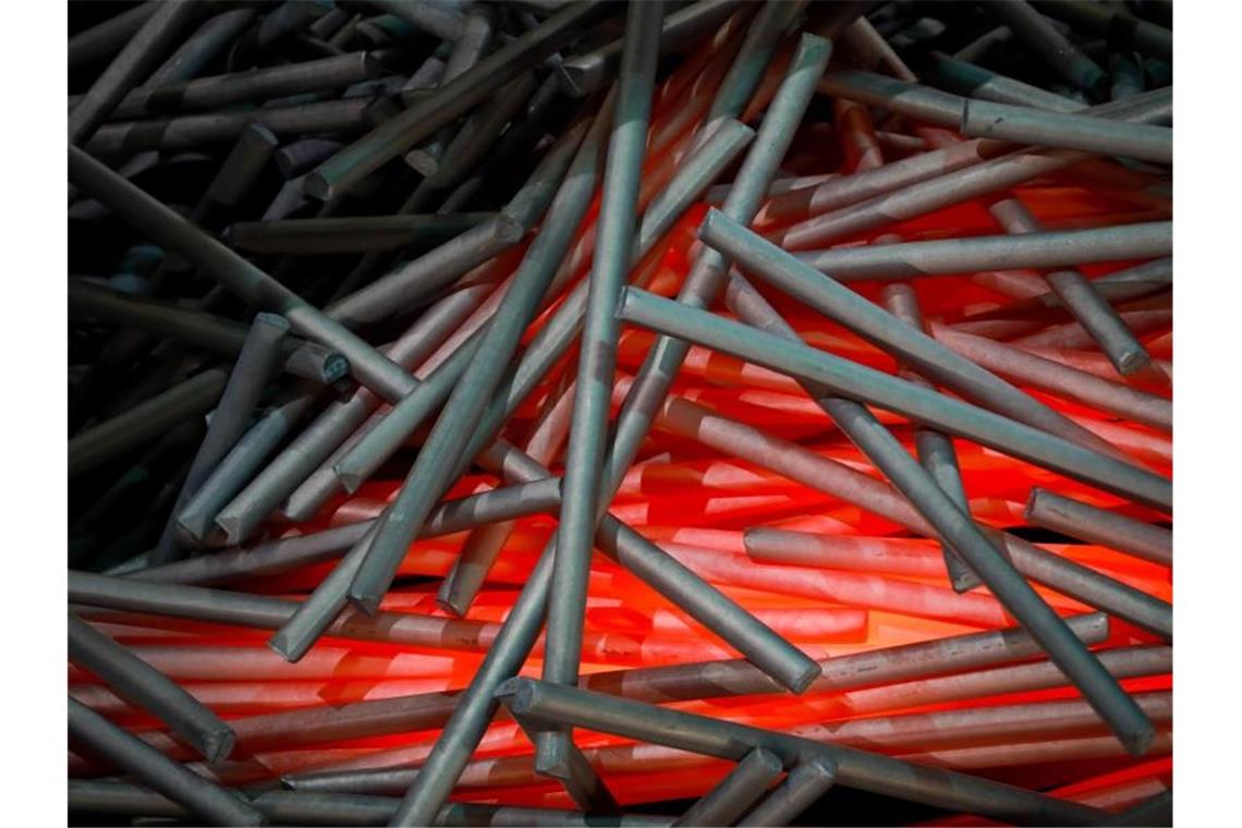 Reste von glühenden Stahlsträngen: Die US-Strafzölle auf die Stahl- und Aluminium-Importe der EU-Länder traten ab dem 8. Februar in Kraft. Foto: Christian Charisius/dpa