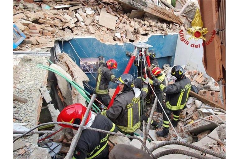 Rettungskräfte der Feuerwehr vor dem eingestürzten Wohnhaus in Turin. Foto: --/Vigili del Fuoco/dpa