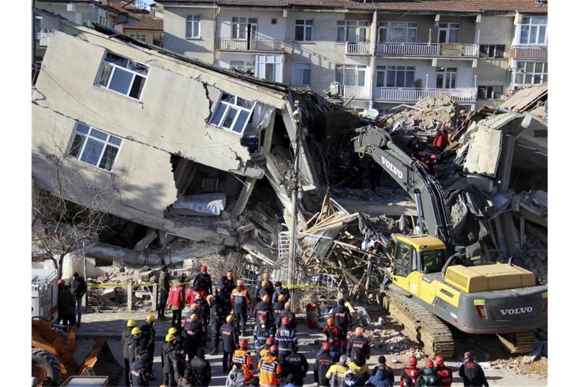Rettungskräfte sind an einem eingestürzten Gebäude in Elazig im Einsatz. Foto: -/IHA/AP/dpa