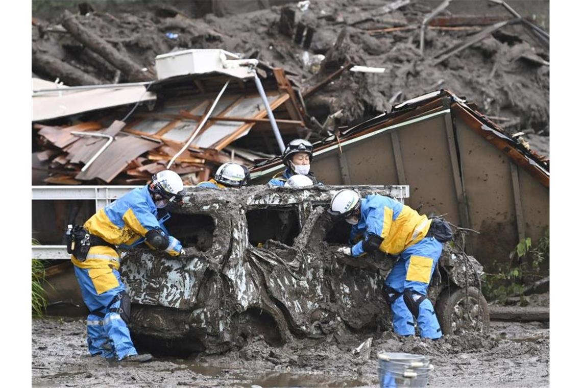 Rettungskräfte suchen nach mehreren Vermissten, doch der Regen erschwert die Aufgabe. Foto: Uncredited/Kyodo News via AP/dpa