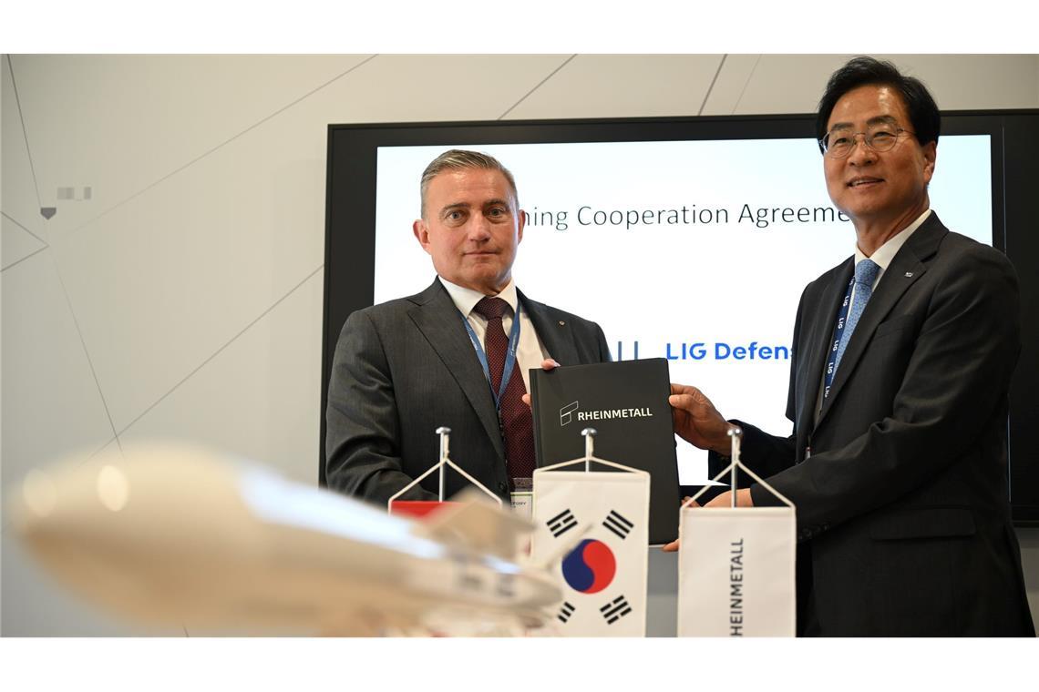 Rheinmetall-Manager Oliver Dürr und der südkoreanische Manager Ickhyun Shin nach der Unterschrift der Vereinbarung bei der Eurosatory.
