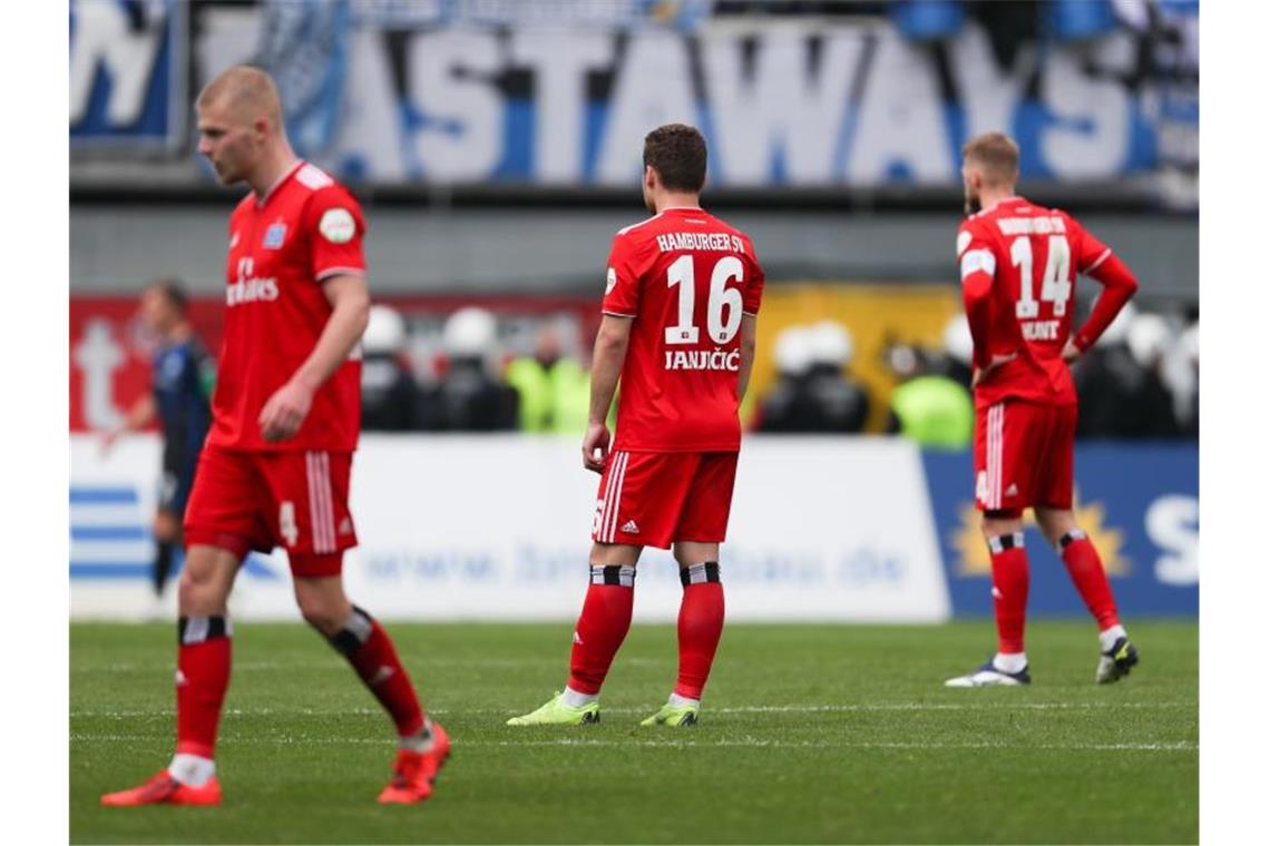 HSV verpasst Rückkehr - Tränen in Duisburg und Magdeburg Rick van Drongelen (l-r), Vasilije Janjicic und Aaron Hunt aus Hamburg zeigen sich enttäuscht bei Spielende. Foto: Friso Gentsch