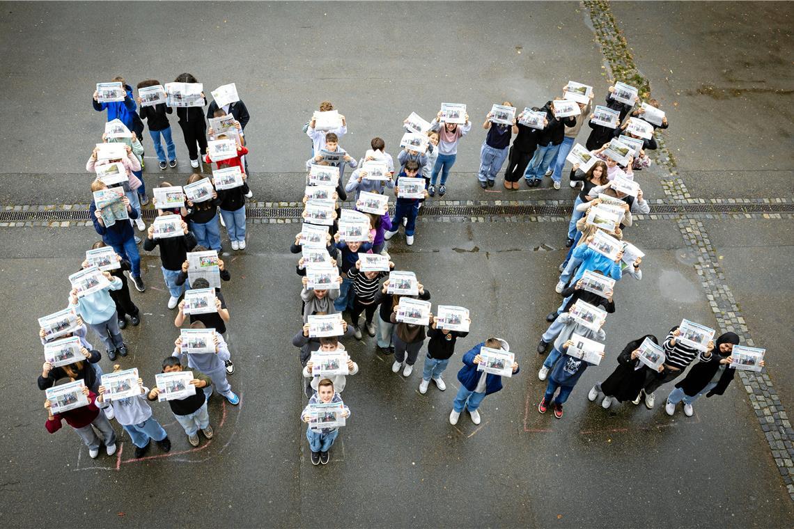 Die Zeitung hautnah kennenlernen Schülerinnen und Schüler der 8. Jahrgangsstufe an der Max-Eyth-Realschule erhalten am ersten Projekttag ihre Zeitungen. Damit werden sie direkt kreativ und stellen sich im Schulhof zu einem großen „BKZ“ auf. Foto: Alexander Becher