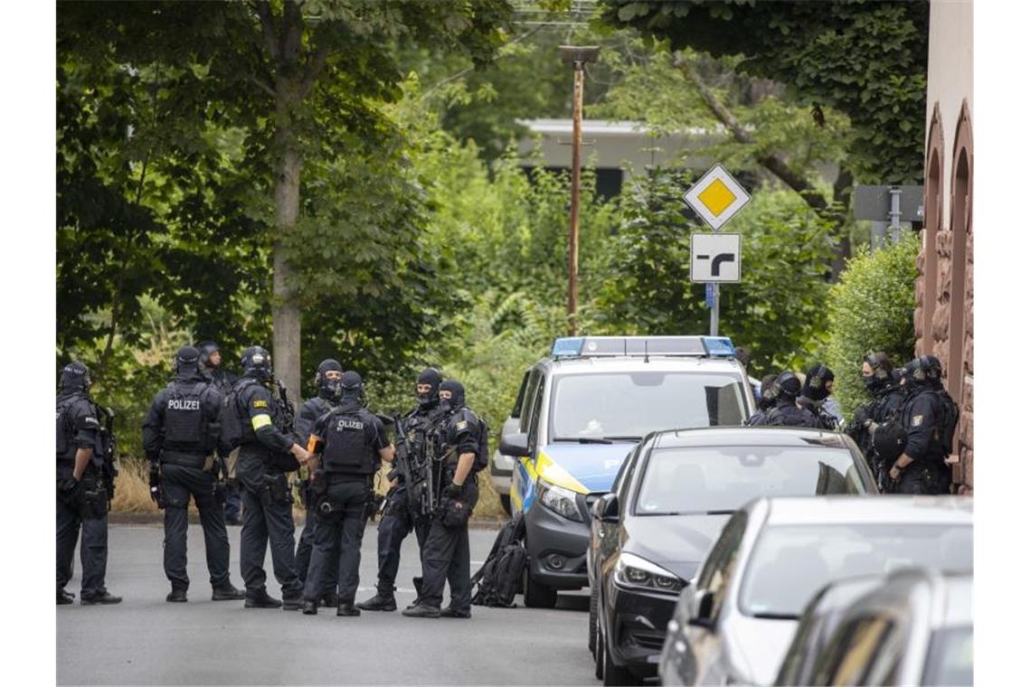 Schwer bewaffnete Polizisten sichern eine Straße in Frankfurt. Foto: Helmut Fricke/DPA/dpa