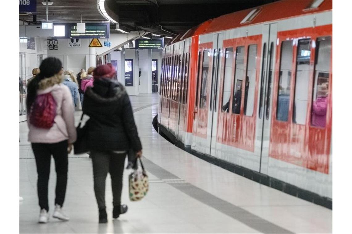 Sehr viel weniger Fahrgäste als üblich stehen auf einem Bahnsteig der S-Bahn Jungfernstieg in Hamburgs Innenstadt. Foto: Markus Scholz/dpa