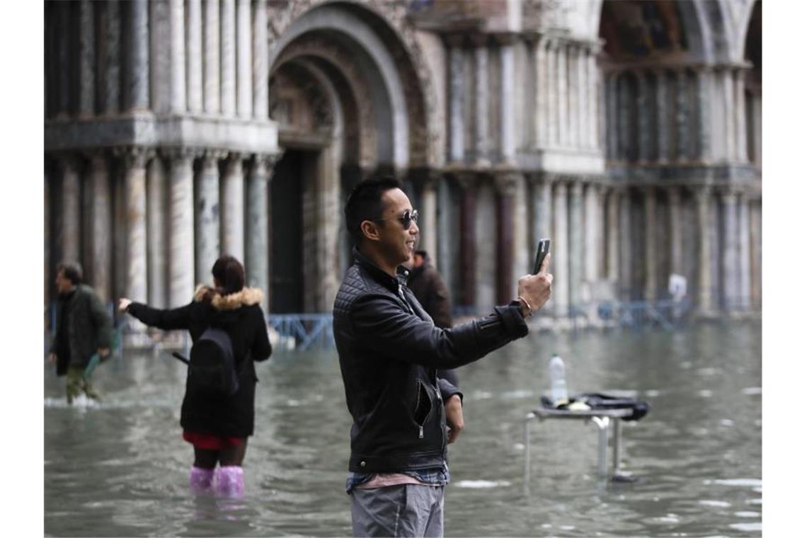 Selfie auf dem überfluteten Markusplatz. Foto: Luca Bruno/AP/dpa