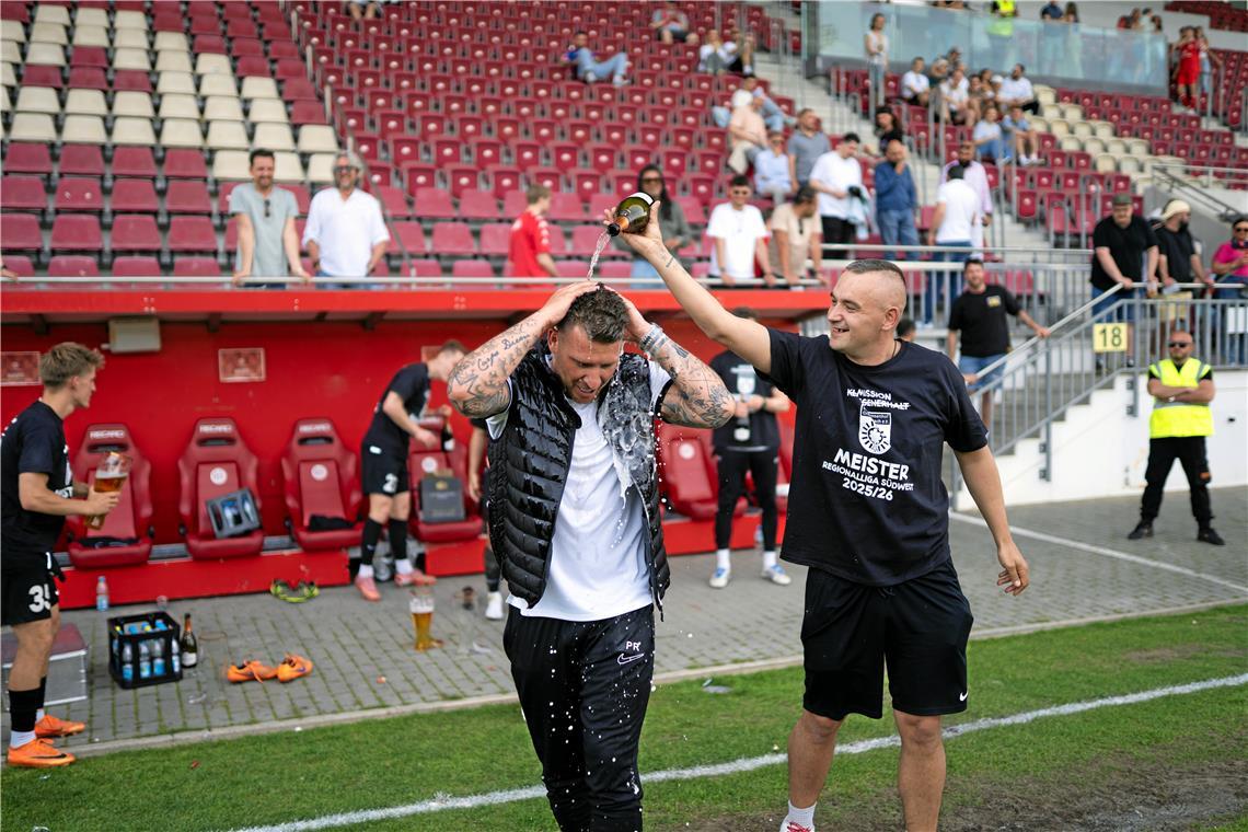 SG-Trainer Pascal Reinhardt bekommt eine Sektdusche von Betreuer Kay Ihde, 
