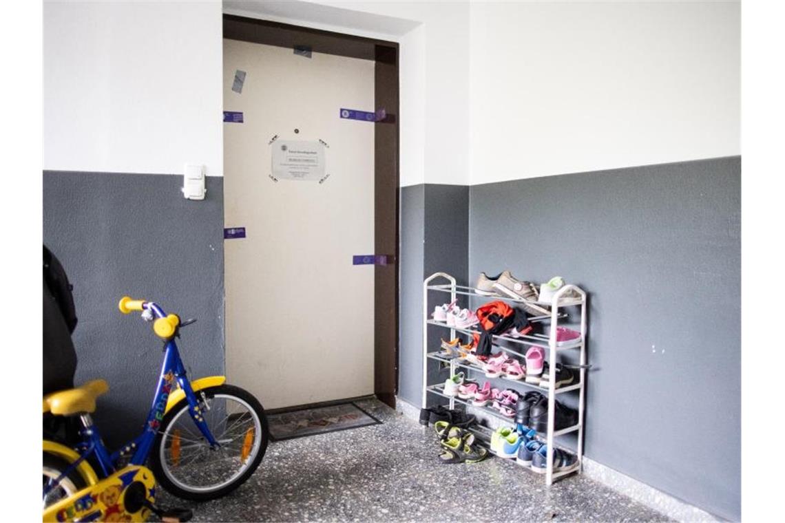 Siegel der Polizei hängen an einer Wohnungstür in einem Wohnhaus. Foto: Marcel Kusch/dpa
