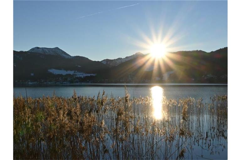 Sonne hinter den Bergen im Tegernseer Tal in Bayern. Foto: Katrin Requadt/dpa