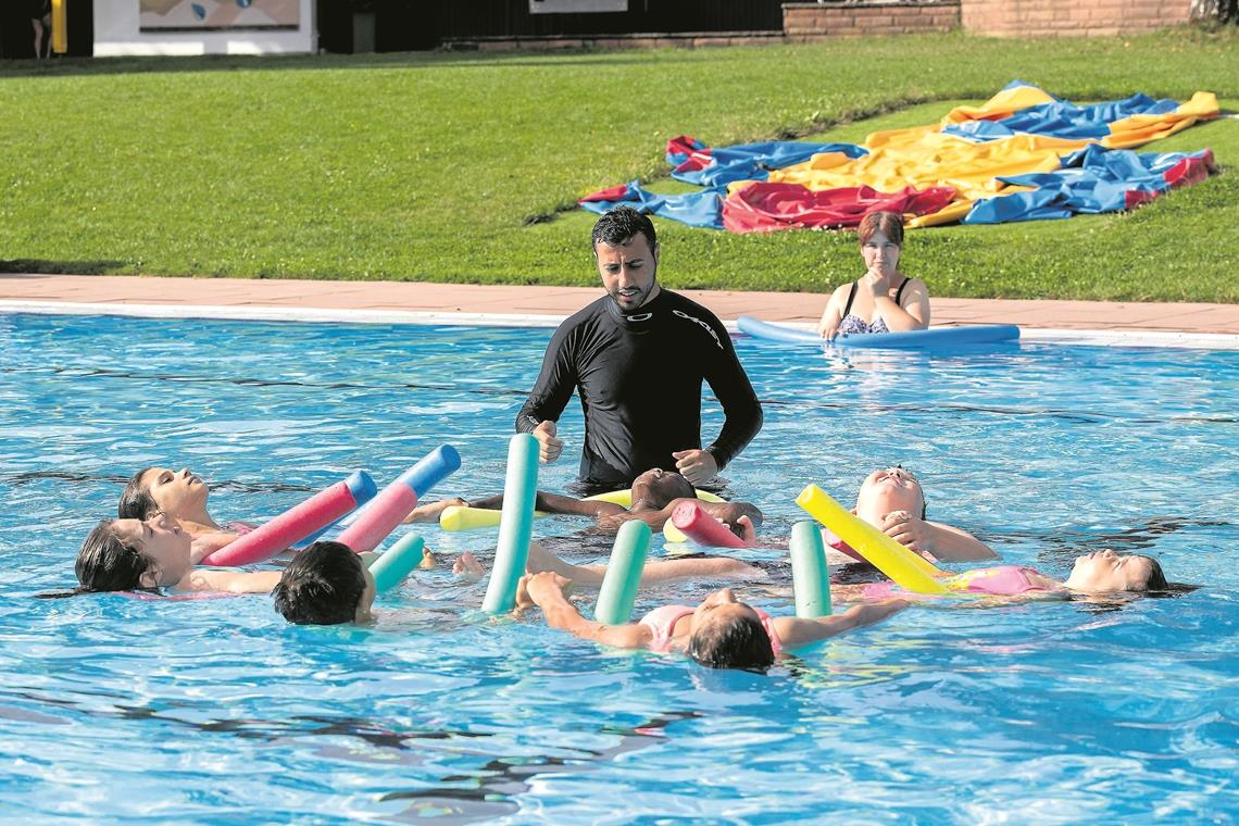 Crashlehrgang im kühlen Nass Spielerisch die Angst verlieren: Abdulfatt Wis zeigt den Kindern mit ihren Schwimmnudeln, wie die Haltung im Wasser sein sollte. Foto: J. Fiedler