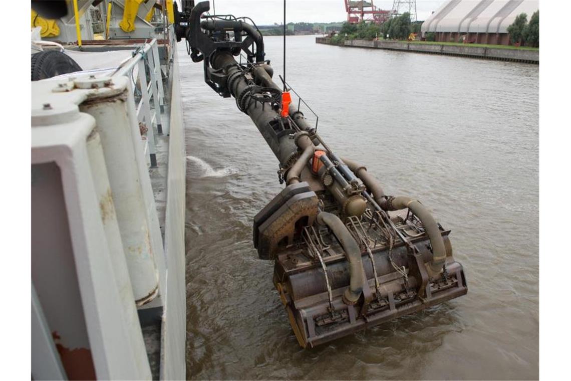 Jetzt wird gebaggert - Startsignal für die Elbvertiefung Start für die Elbvertiefung in Hamburg: Der Saugkopf des Baggerschiffes „Bartolomeu Dias“ wird in den Fluss gesenkt. Foto: Daniel Reinhardt