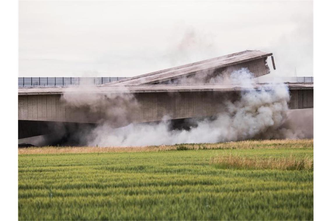 Staubwolken steigen während der Sprengung der Brücke auf. Foto: Andreas Arnold