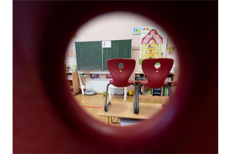 Stühle stehen in einem Klassenzimmer einer ersten Klasse der Marienschule in Stuttgart auf Tischen. Foto: Marijan Murat/dpa