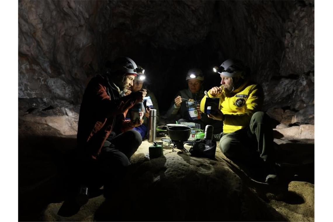 Freiwillige verlassen nach 40 Tagen Höhle in den Pyrenäen Teilnehmer der Studie „Deep Time“ beim Essen in der Höhle in den französischen Pyrenäen. Foto: -/Human Adaptation Institute/AP/dpa