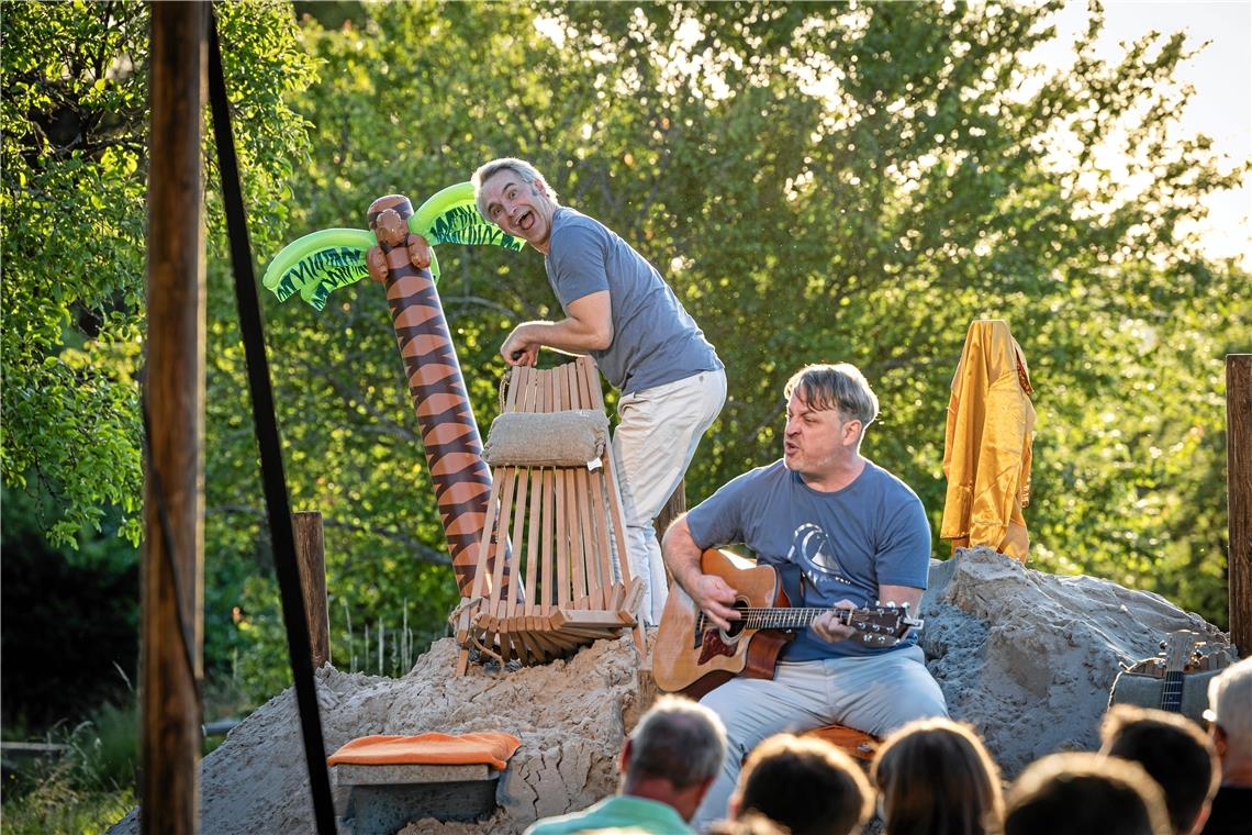 Beim Klimawandel hört der Spaß nicht auf Thomas Weber (links) legt Hand an, damit das Ambiente noch besser passt, und pumpt sein Plastikpälmchen auf. James Geier unterstützt mit dem Song „Wenn jetzt Sommer wär“. Foto: Alexander Becher
