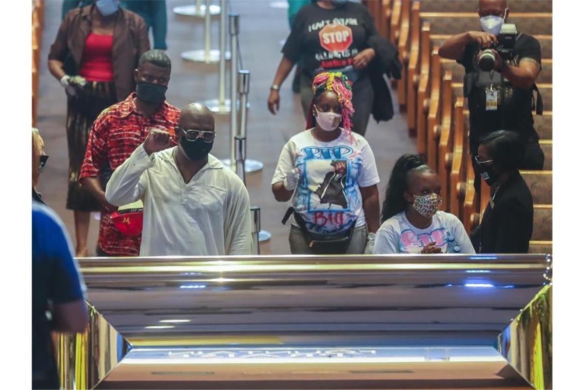 Trauergäste stehen vor dem goldfarbenen Sarg in der „The Fountain of Praise“ Kirche. Foto: Godofredo A. Vásquez/Pool Houston Chronicle/AP Pool/dpa