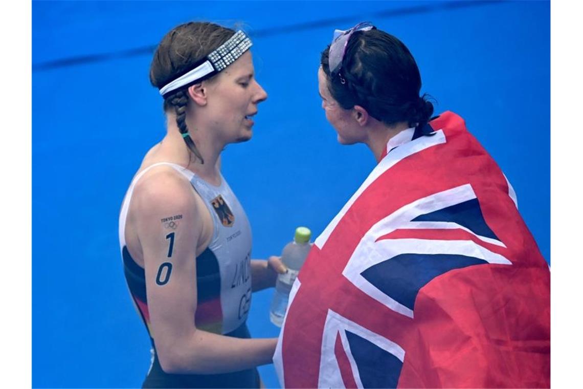 Triathletin Laura Lindemann gratuliert Flora Duffy zum Sieg Olympiasieg. Foto: Sebastian Gollnow/dpa