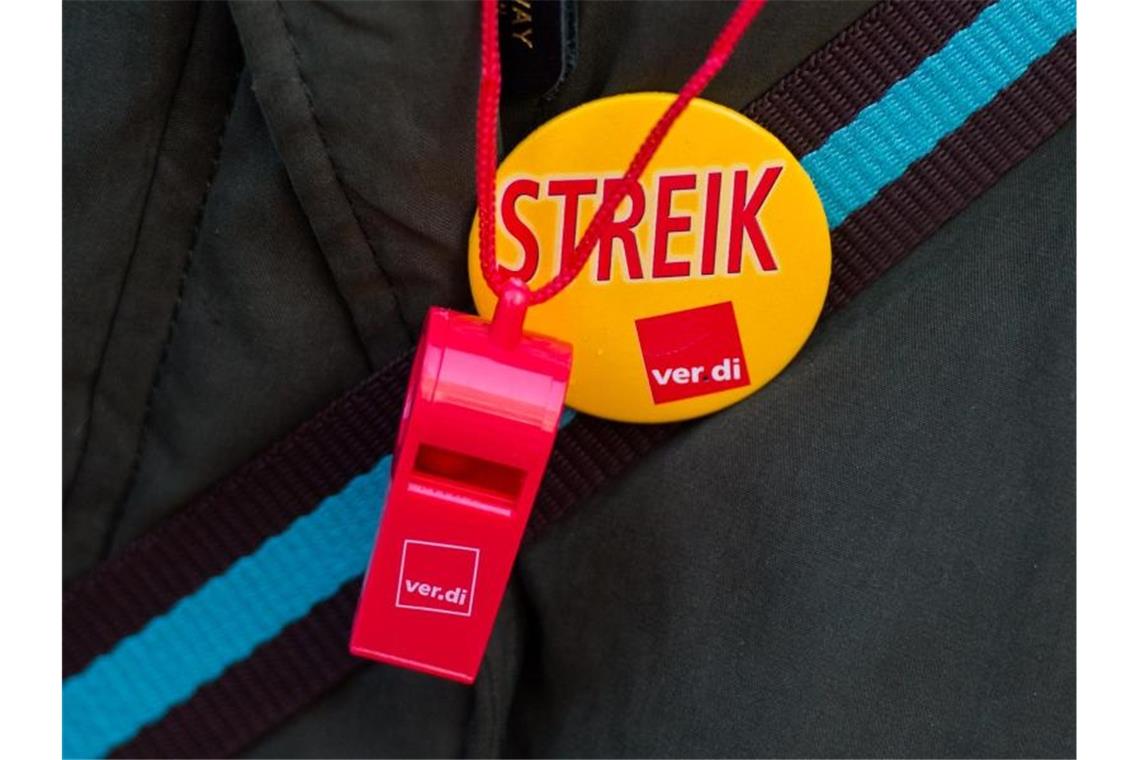 Trillerpfeife mit Verdi-Logo und Button mit der Aufschrift „Streik“. Foto: Daniel Bockwoldt/dpa/Archivbild