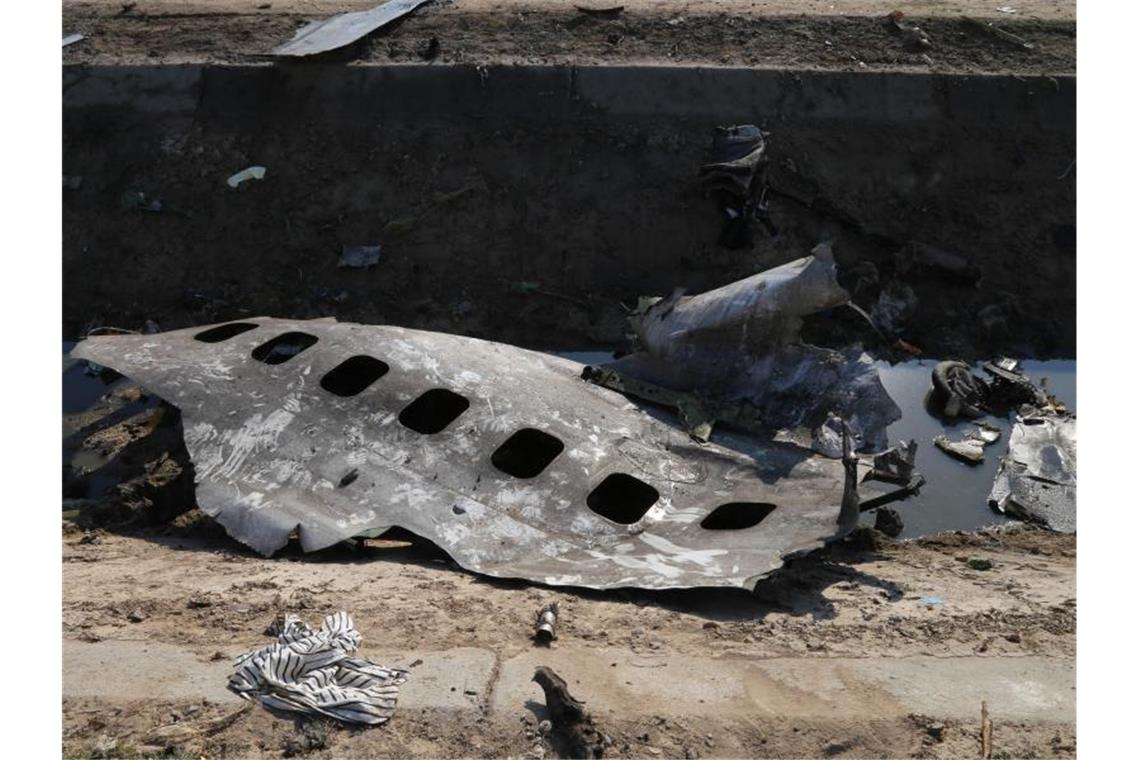 Trümmerteile der ukrainischen Passagiermaschine liegen am Absturzort. Foto: Rouzbeh Fouladi/ZUMA Wire/dpa