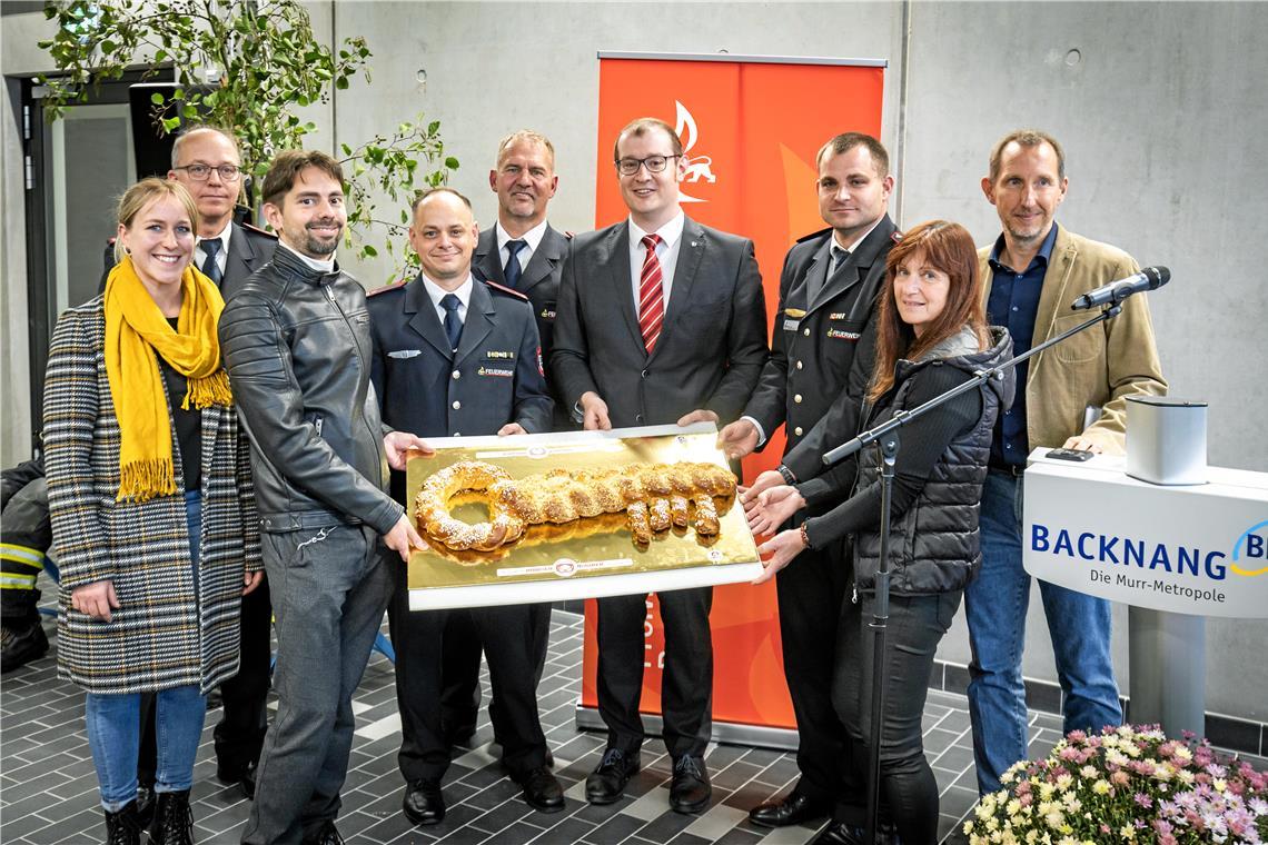 Neues Domizil für die Feuerwehr im Süden Übergabe des süßen Schlüssels (von links): Rabea Rauh, Oliver Gräter, Alexander Colettis, Oliver Werner, Bernd Haisch, Maximilian Friedrich, Stefan Burr, Dagmar Langer, Martin Wypior.
