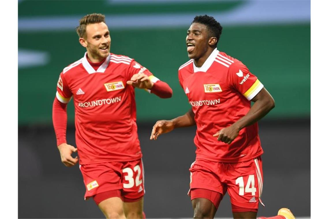 Schalke verliert bei Gross-Debüt - Leipzig an der Spitze Unions Marcus Ingvartsen (l) feiert Torschütze Taiwo Awoniyi. Foto: Carmen Jaspersen/dpa