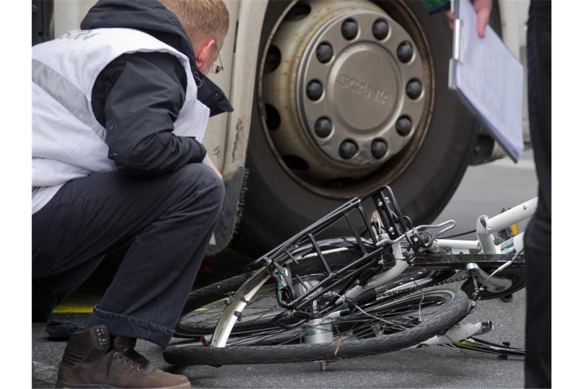 Unter dem Lkw: Polizisten und Gutachter bergen in Berlin ein völlig zertrümmertes Fahrrad. Foto: Tim Brakemeier
