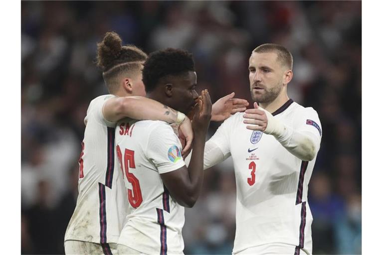 Untröstlich: Kalvin Phillips (l) und Luke Shaw (r) versuchen Bukayo Saka nach seinem Fehlschuss aufzurichten. Foto: Carl Recine/Pool Reuters/AP/dpa