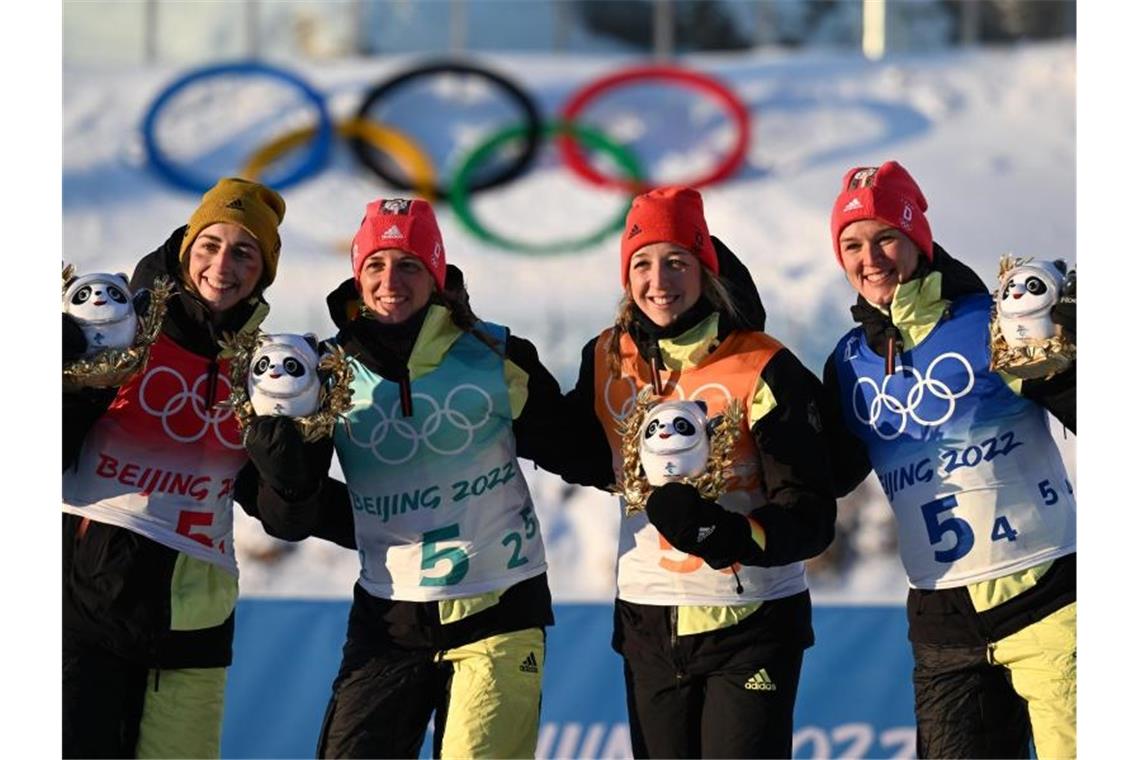 Vanessa Voigt (l-r), Vanessa Hinz, Franziska Preuss und Denise Herrmann freuen bei der Flower Ceremony über olympisches Bronze. Foto: Hendrik Schmidt/dpa-Zentralbild/dpa