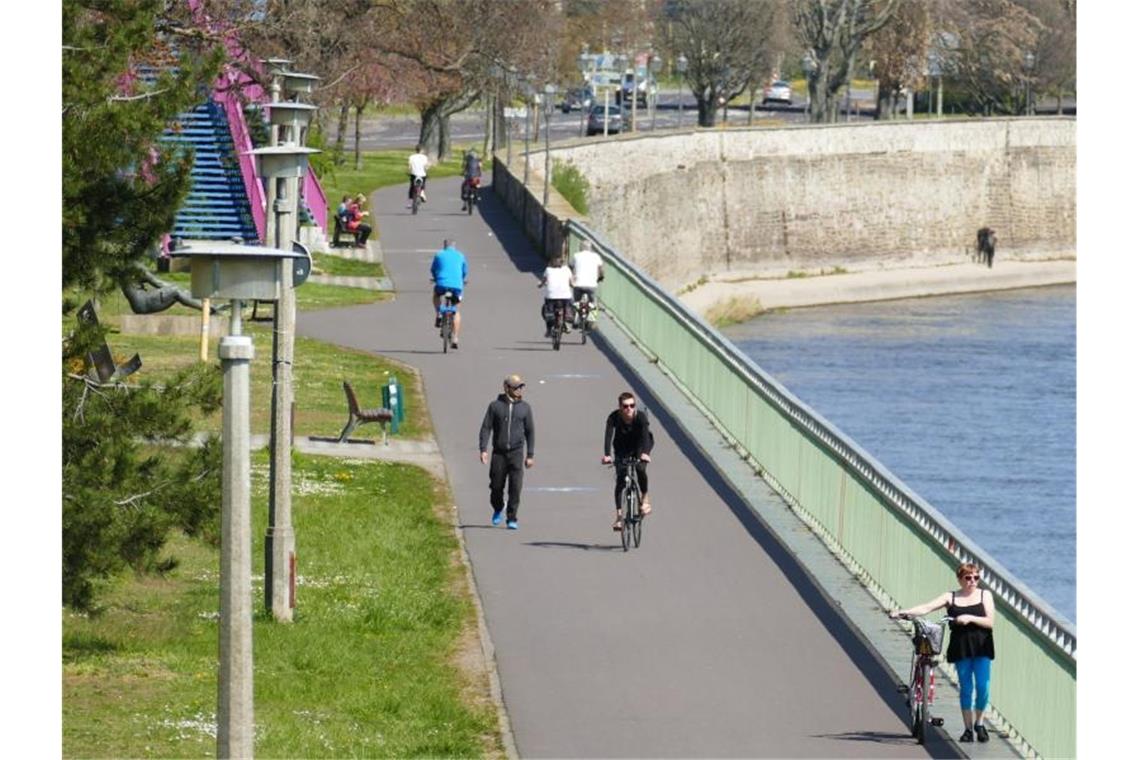 Vereinzelte Fußgänger und Radfahrer nutzen den Weg entlang der Elbe in der Magdeburger Innenstadt. Foto: Sabrina Gorges/dpa-Zentralbild/dpa