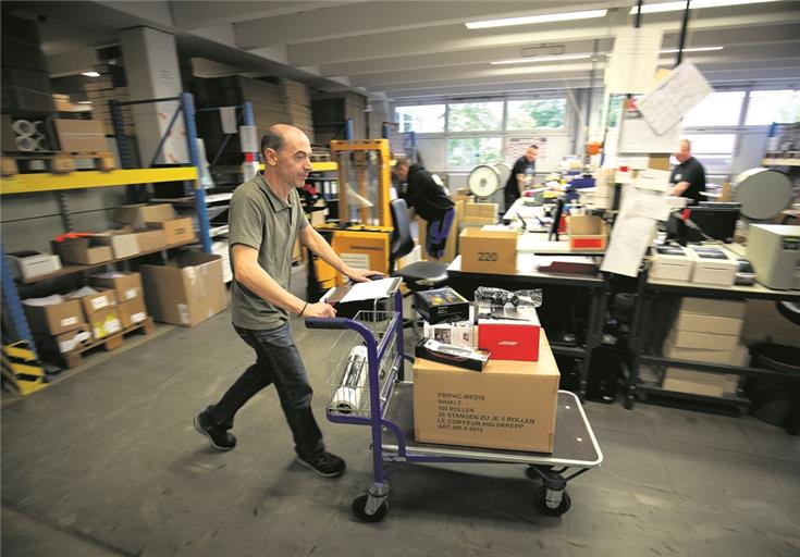 Verpacken die Artikel für ihren Weg zu Großhändlern: Mario Pace und weitere sieben Mitarbeiter, die im Lager beschäftigt sind. Foto: A. Becher