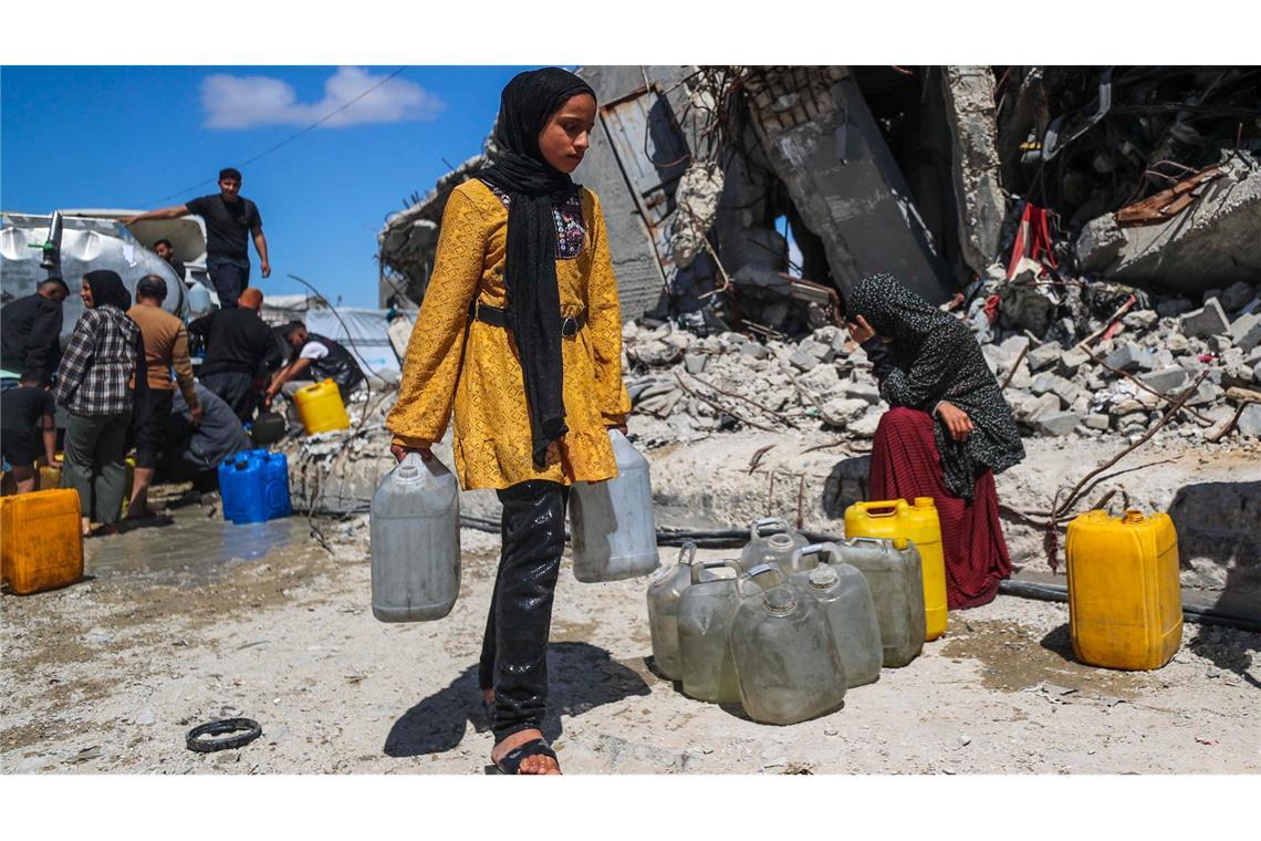 Bilder des Tages Vertriebene Palästinenser holen im Flüchtlingslager Jabalia im nördlichen Gazastreifen mit Kanistern Wasser.