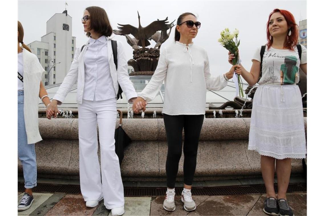 Weiß gekleidete Frauen bilden während eines Protests eine Menschenkette. Demonstranten gehen in der belarussischen Hauptstadt und in anderen Städten auf die Straße und drängen weiterhin auf den Rücktritt des autoritären Führers des Landes. Foto: Dmitri Lovetsky/AP/dpa