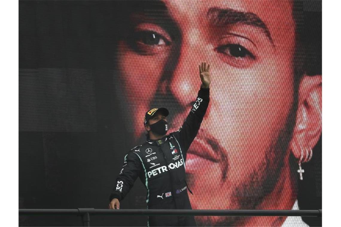Weltmeister Lewis Hamilton vom Team Mercedes jubelt über seinen 92. Karrieresieg. Foto: Jose Sena Goulao/EPA Pool/AP/dpa