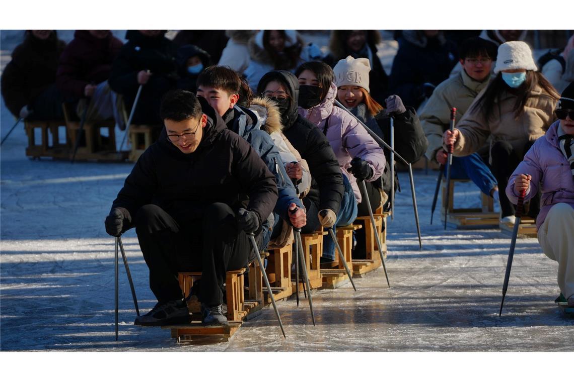 Wochenendspaß auf dem Eis: Stuhl-Skifahren im Park von Peking