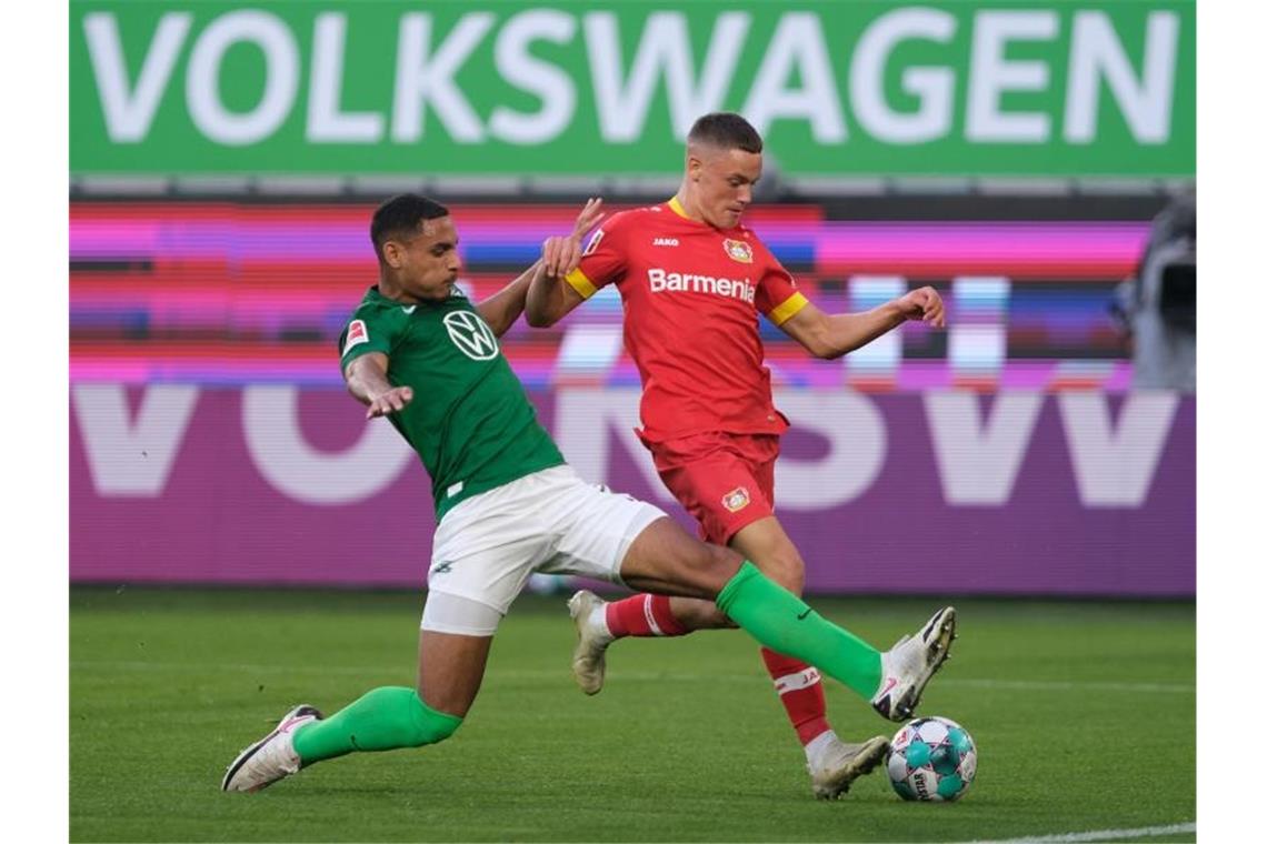 Nullnummer in Wolfsburg: Leverkusen ohne Havertz zu harmlos Wolfsburgs Neuzugang Maxence Lacroix (l) setzt gegen Leverkusens Talent Florian Wirtz zur Grätsche an. Foto: Peter Steffen/dpa