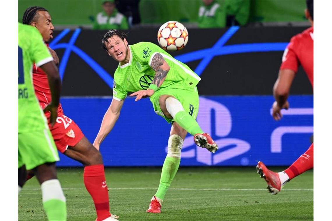 VfL Wolfsburg verpasst Sieg durch späten Elfmeter Wolfsburgs Wout Weghorst versucht es mit einem Schuss auf Sevillas Tor. Foto: Swen Pförtner/dpa